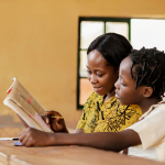 teacher helping kids class.webp